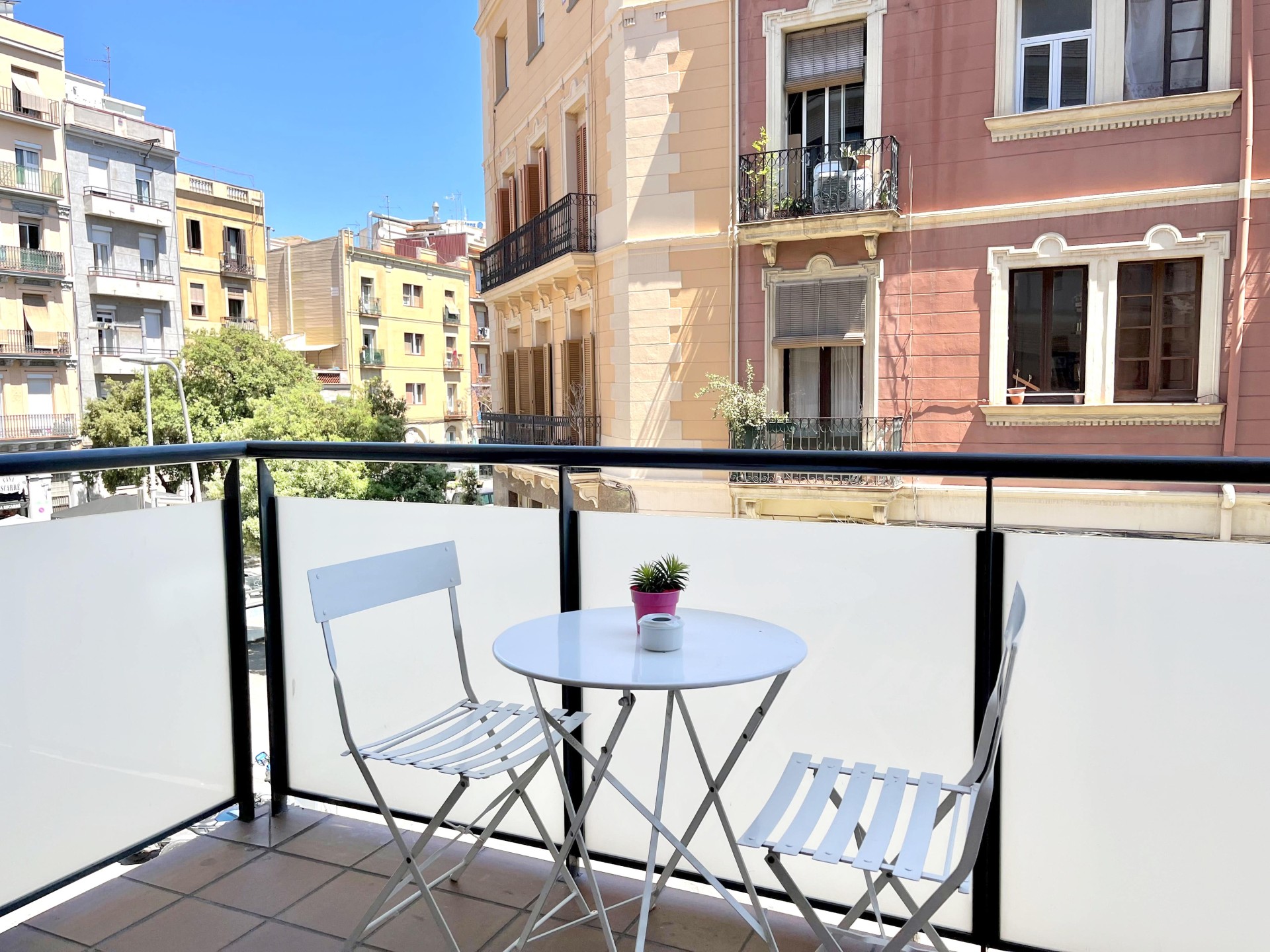 Terrace with table and views of a typical Barcelona neighborhood